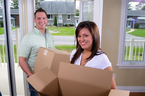 Professional flat removals in Upperwalthamstow with movers carrying boxes