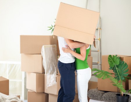 House move preparation with labelled boxes and furniture protection